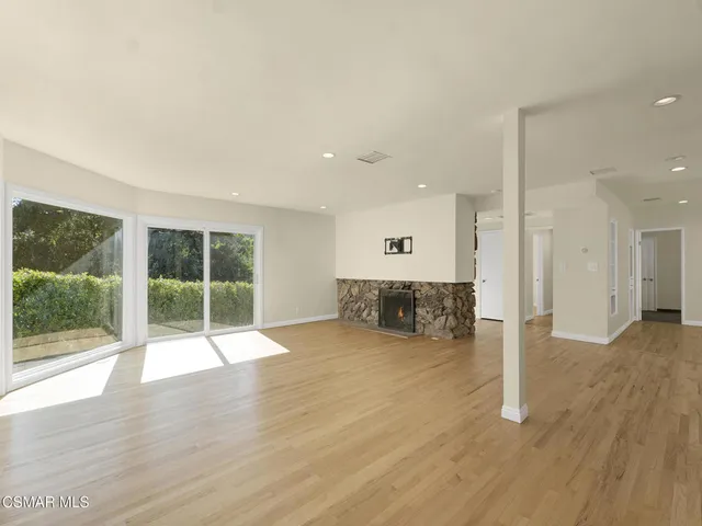 a view of wooden floor and windows in a room