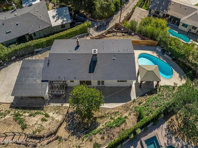 a front view of a house with potted plants