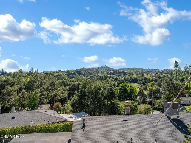 an aerial view of residential houses with outdoor space and street view