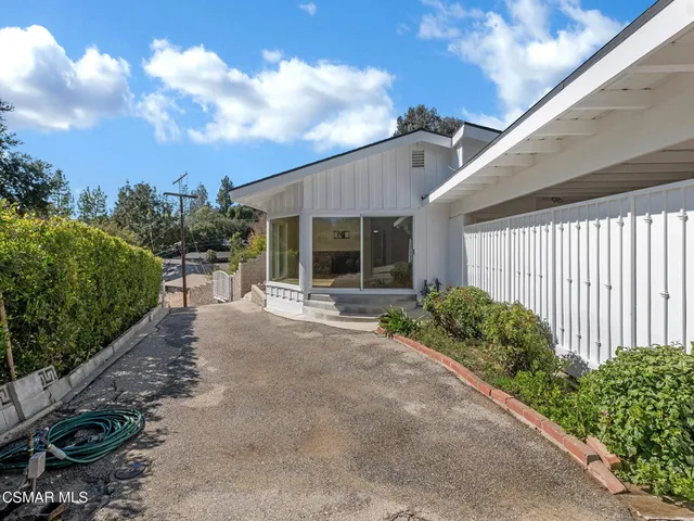 an aerial view of house with yard and mountain view in back