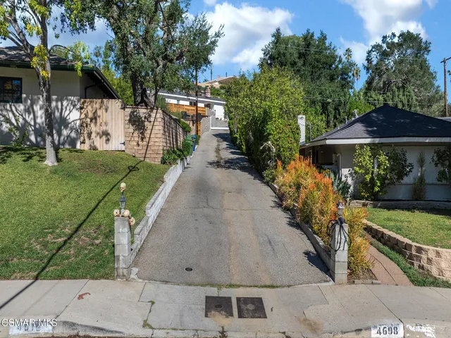 a view of a city with lush green forest