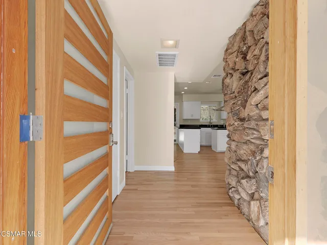 a kitchen with granite countertop a stove a sink and a wooden floors