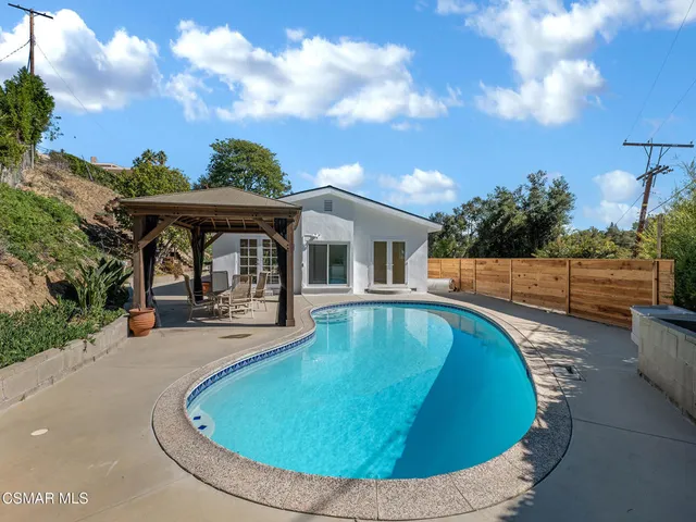 a kitchen with granite countertop a stove and white cabinets