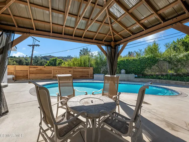 a large kitchen with stainless steel appliances a large counter top a stove and a wooden floors