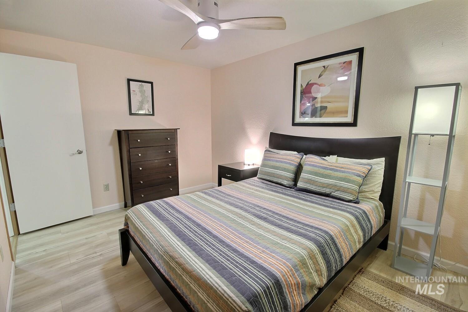 1640 Davis Avenue, Unit 7 McCall, ID 83638 - Photo 13 of 21 Bedroom featuring light wood-style flooring and a ceiling fan