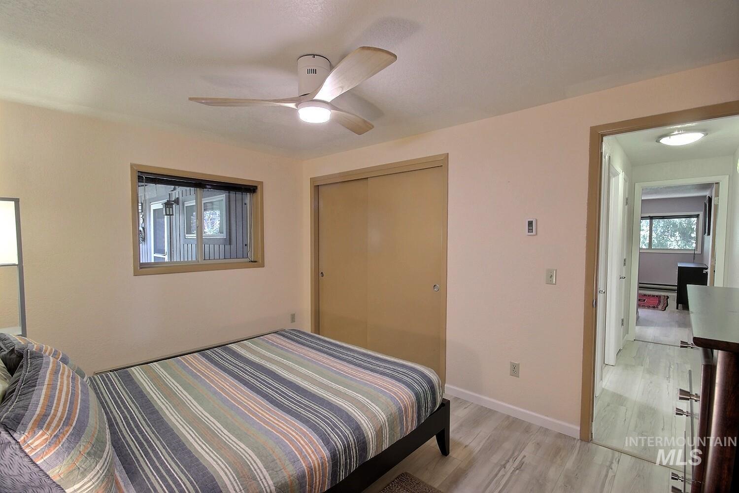 1640 Davis Avenue, Unit 7 McCall, ID 83638 - Photo 14 of 21 Bedroom featuring a ceiling fan, light wood finished floors, and a closet