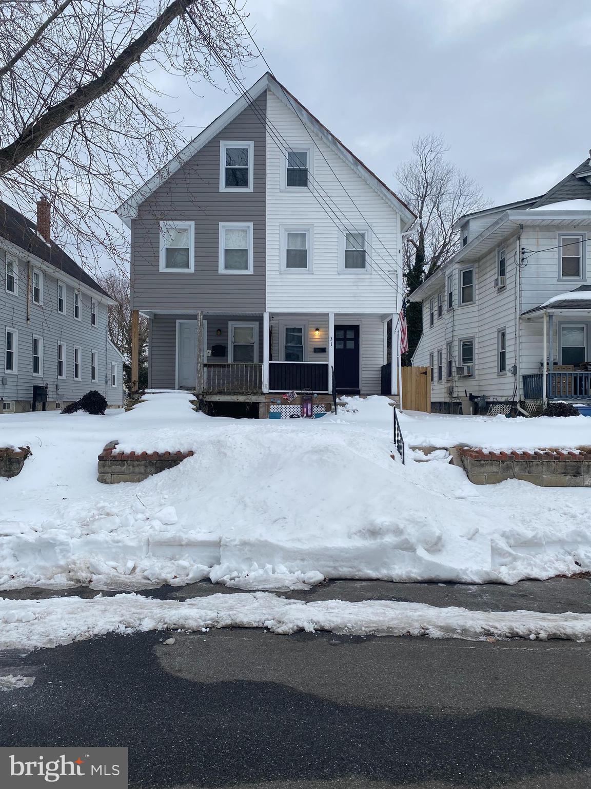 a view of a house with snow on the road