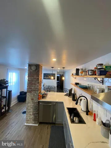 a kitchen with lots of counter top space and furniture