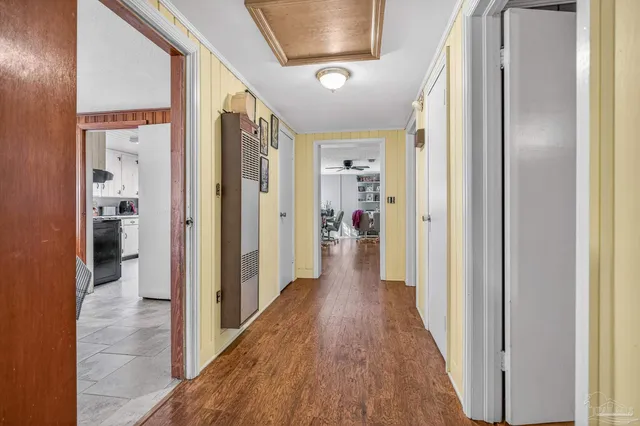 a view of a hallway with wooden floor and staircase