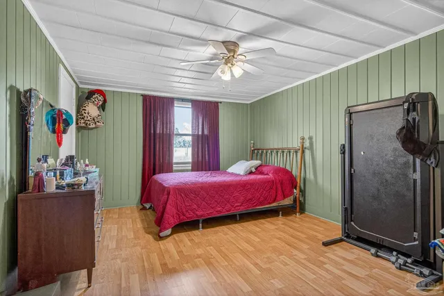 a bedroom with a bed and a mirror