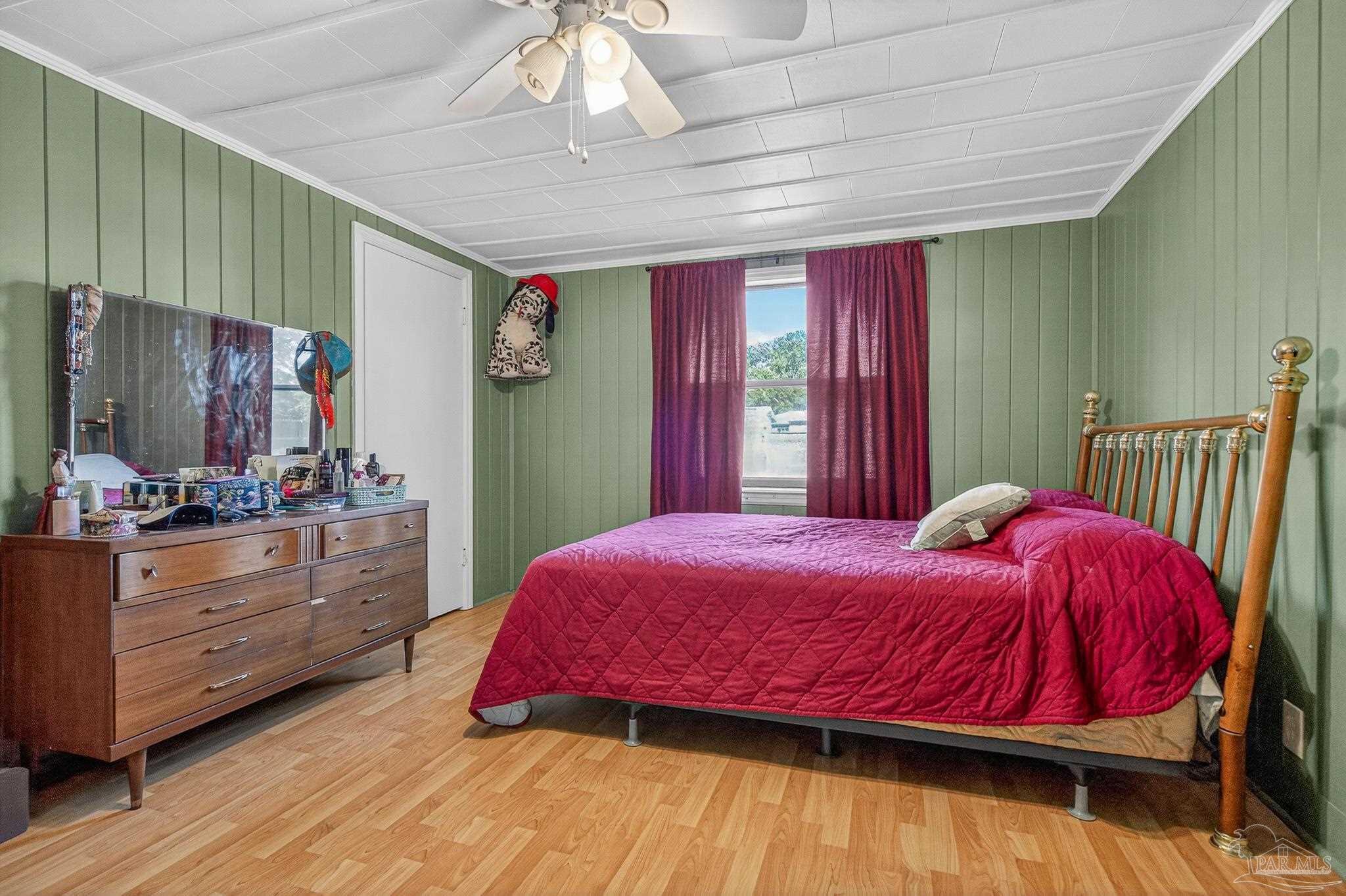 1450 East Burgess Road Pensacola, FL 32504 - Photo 14 of 49 a bedroom with a bed and a dresser