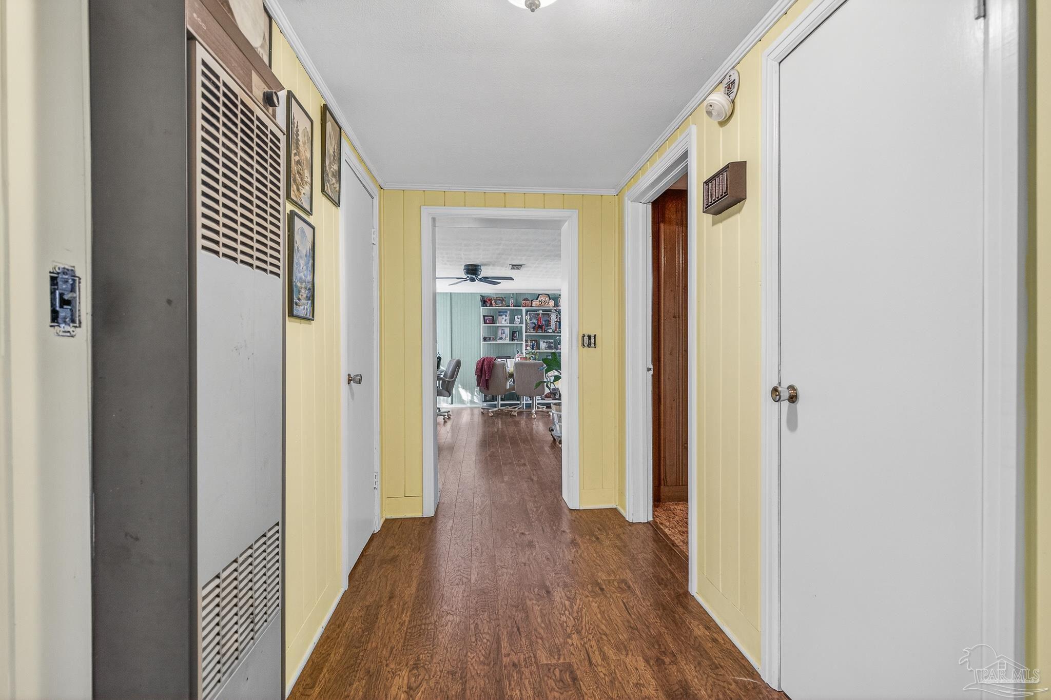 1450 East Burgess Road Pensacola, FL 32504 - Photo 16 of 49 a view of a hallway with wooden floor and a living room