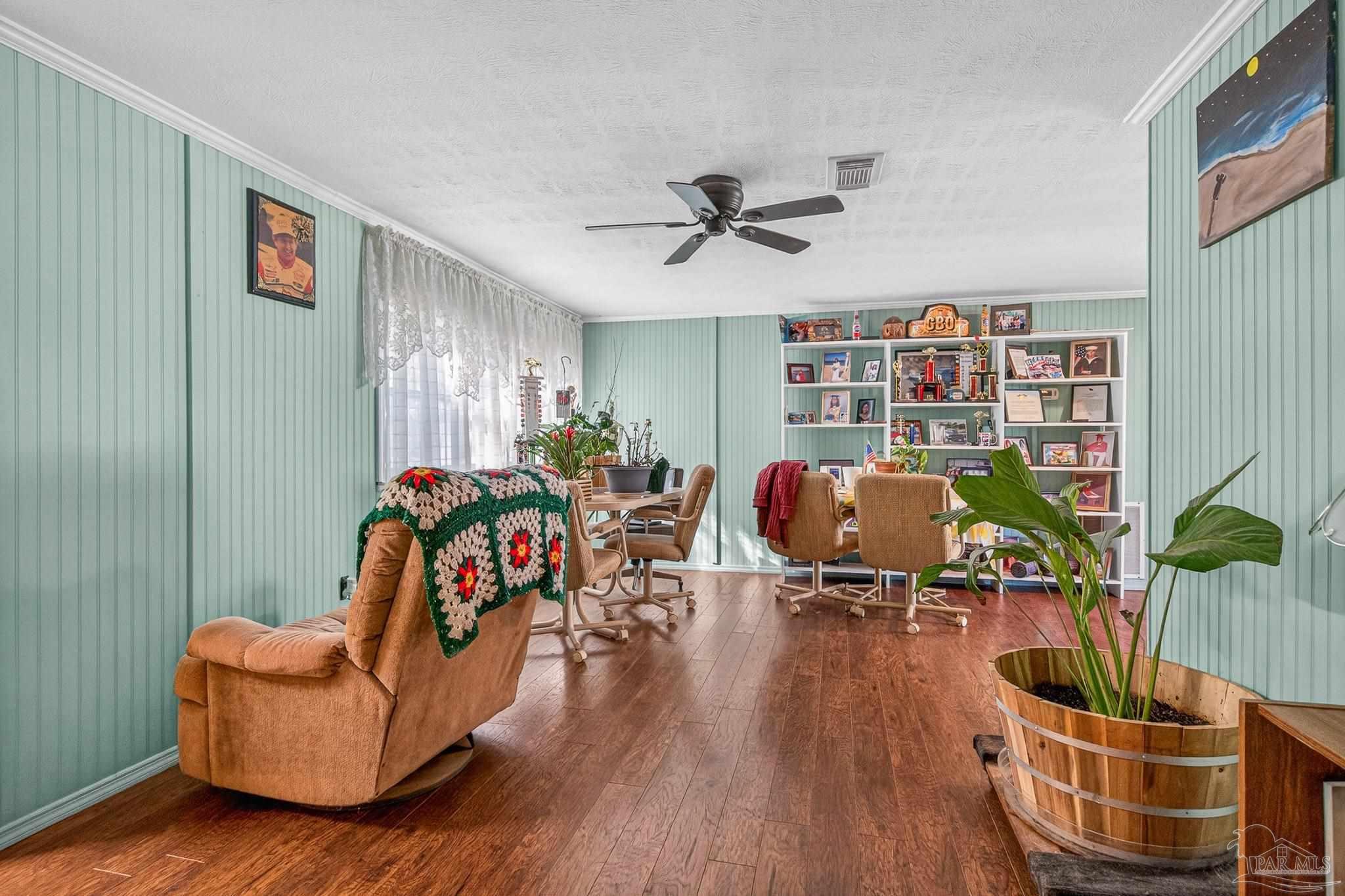 1450 East Burgess Road Pensacola, FL 32504 - Photo 19 of 49 a living room with furniture and a wooden floor