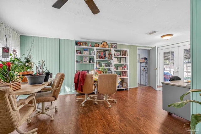 a view of a workspace with furniture and a potted plant