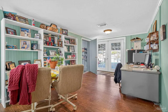 a living room with furniture and a book shelf