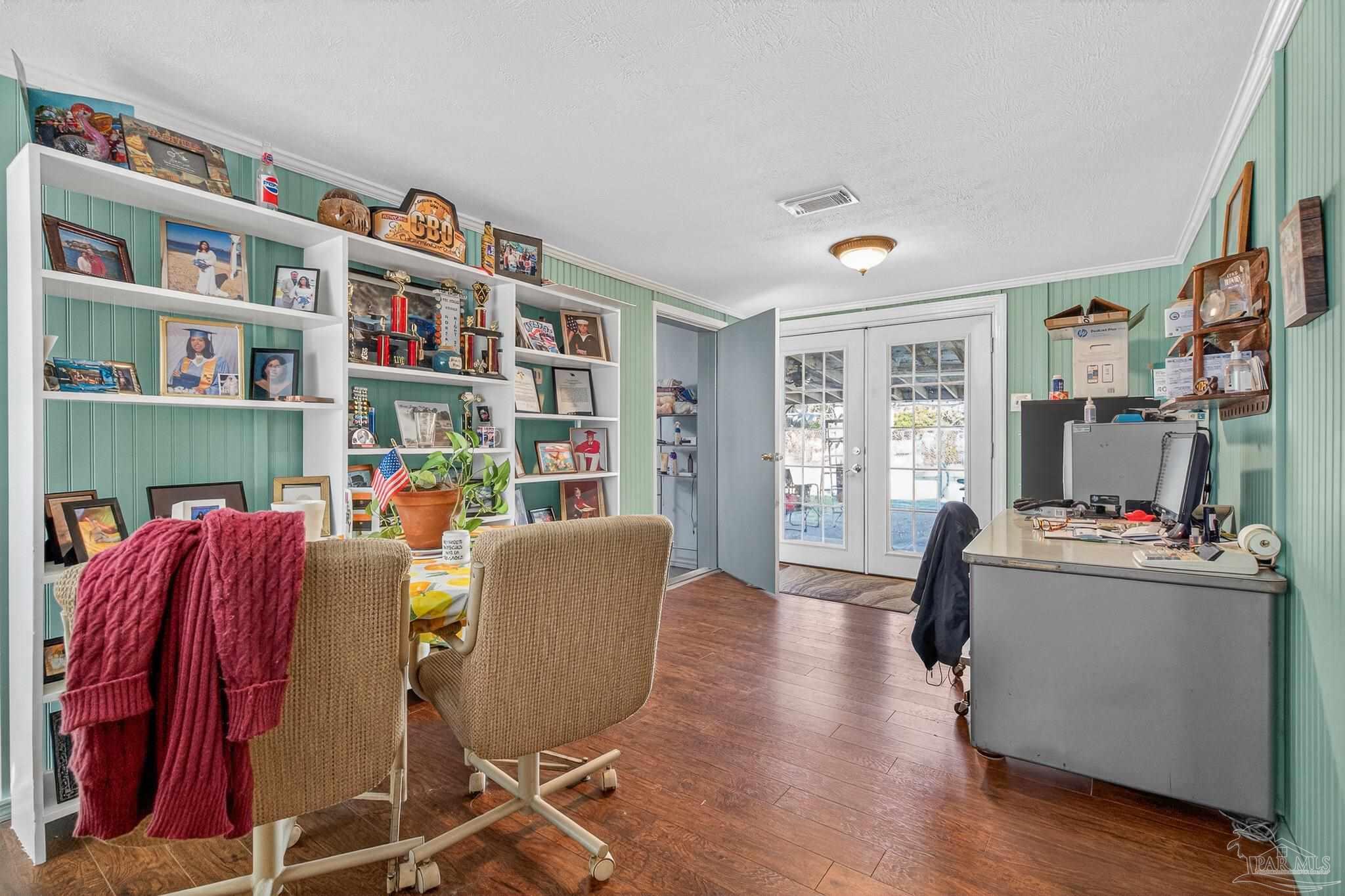 1450 East Burgess Road Pensacola, FL 32504 - Photo 21 of 49 a living room with furniture and a book shelf