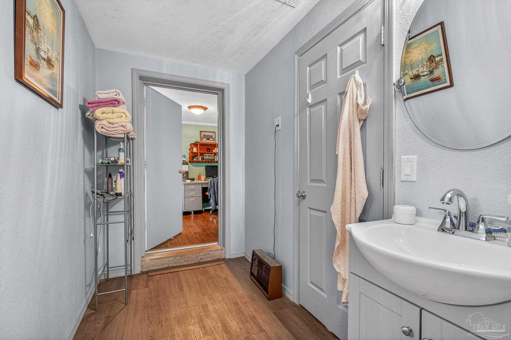 1450 East Burgess Road Pensacola, FL 32504 - Photo 23 of 49 a bathroom with a sink and a mirror