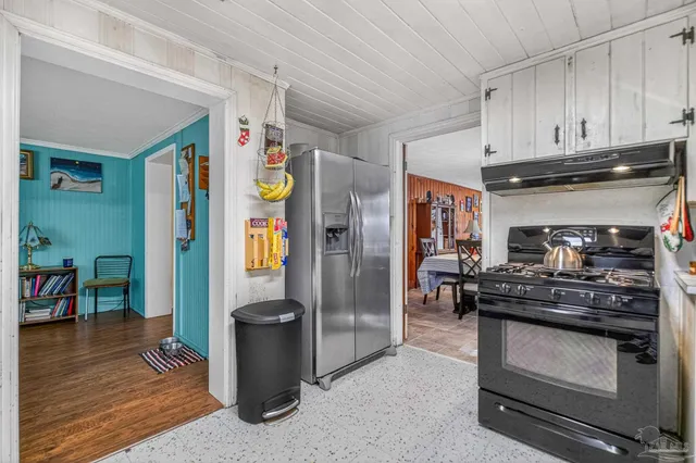 a kitchen with stainless steel appliances granite countertop a refrigerator and stove