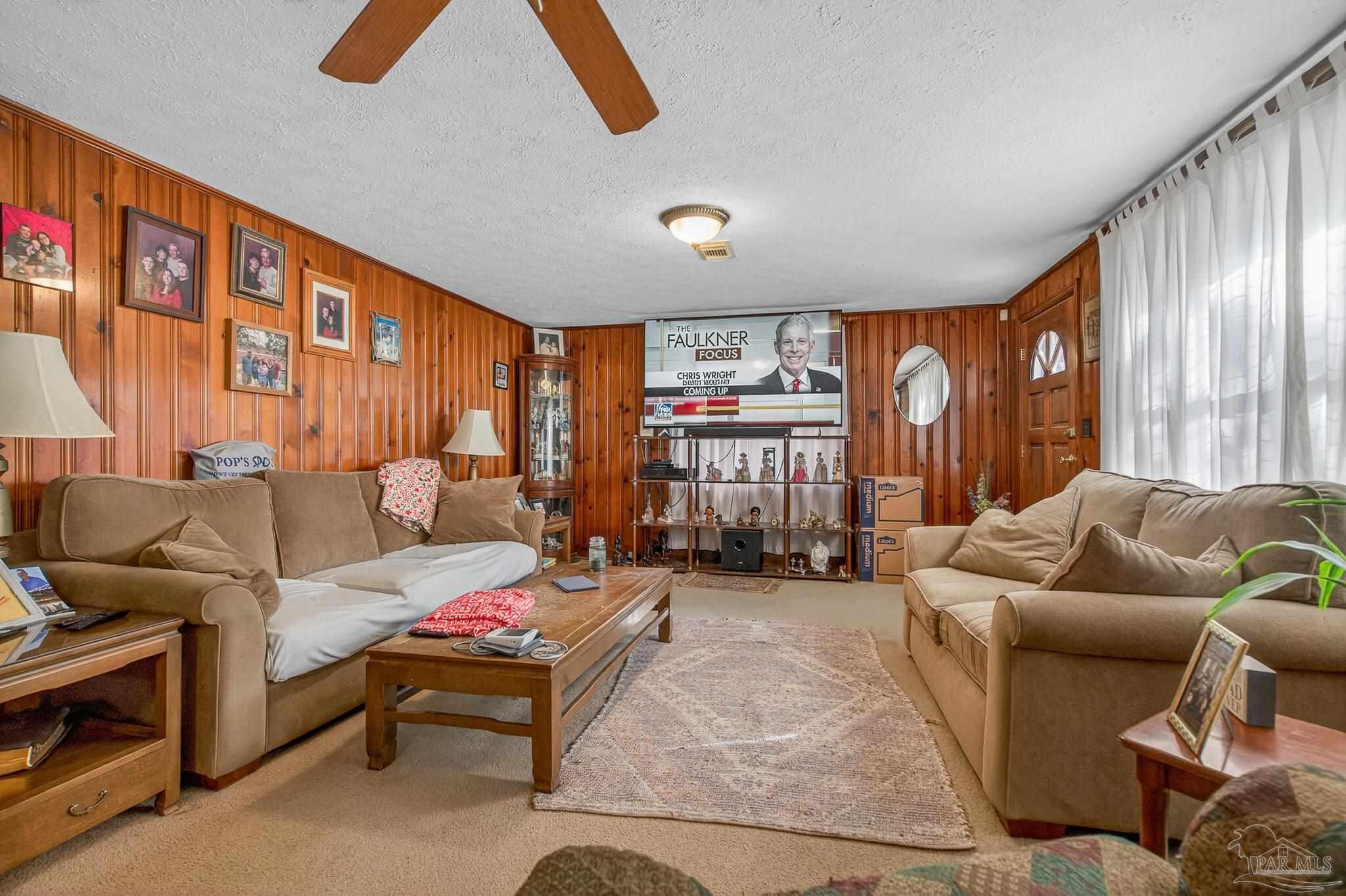 1450 East Burgess Road Pensacola, FL 32504 - Photo 30 of 49 a living room with furniture and a flat screen tv
