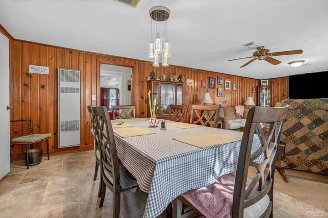 a view of a a dining room with furniture window and wooden floor