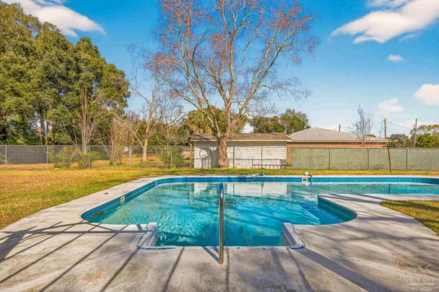 a view of swimming pool with outdoor seating and a pathway