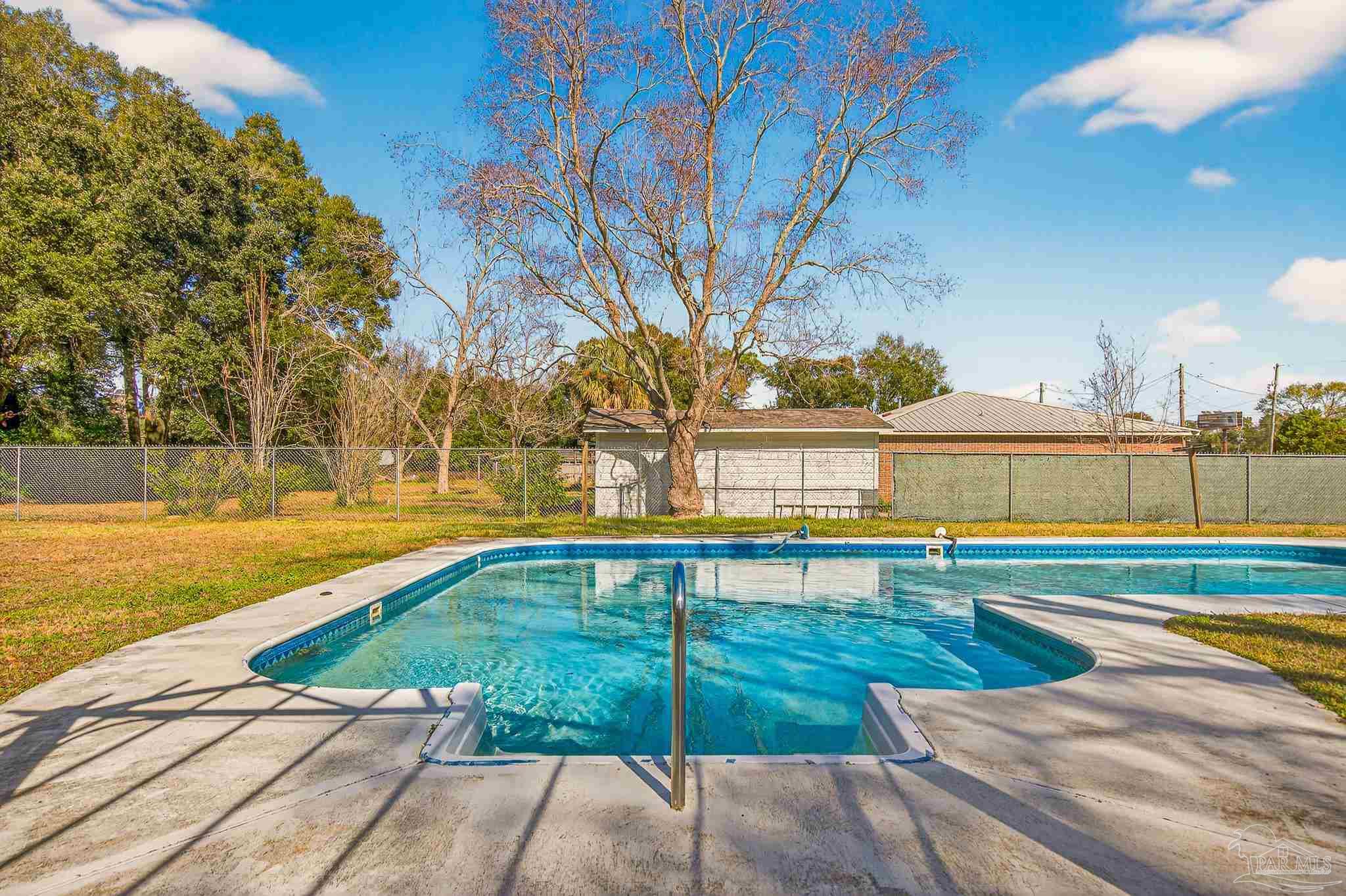 1450 East Burgess Road Pensacola, FL 32504 - Photo 38 of 49 a view of swimming pool with outdoor seating and a pathway