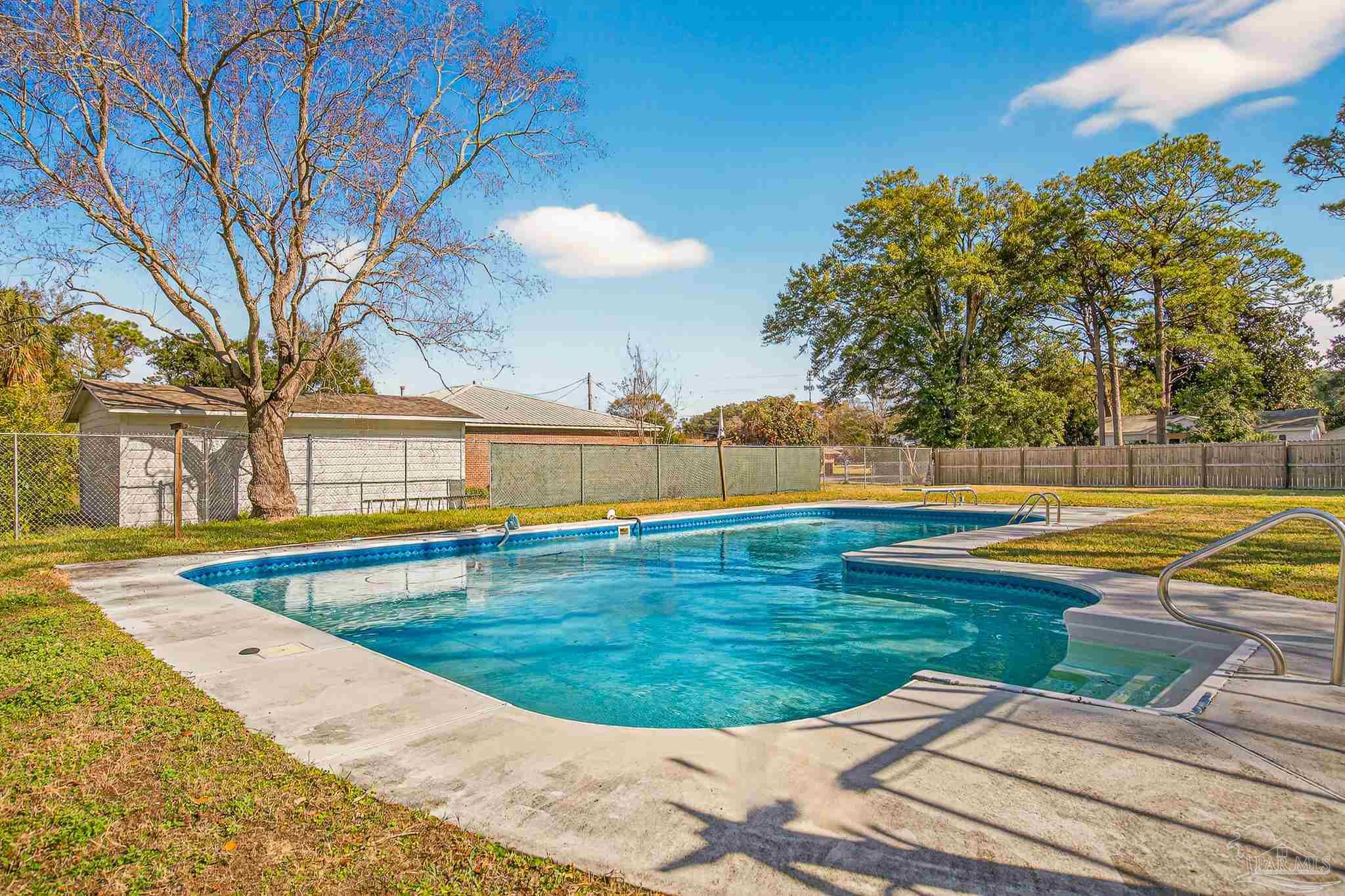 1450 East Burgess Road Pensacola, FL 32504 - Photo 39 of 49 a view of a swimming pool with an outdoor space and seating area