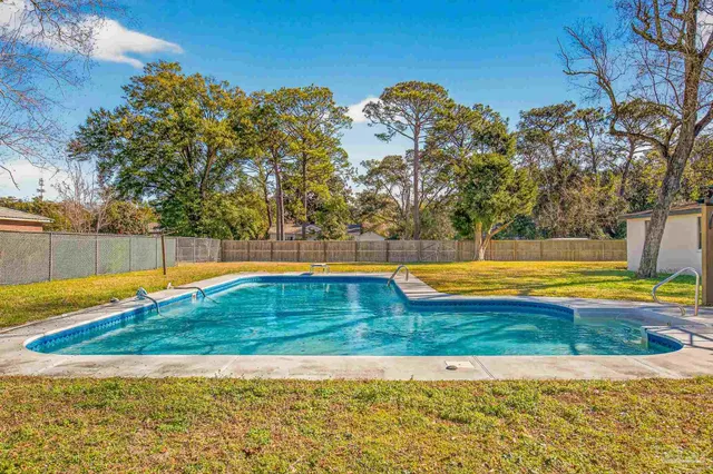 a view of a swimming pool with an outdoor space and seating area