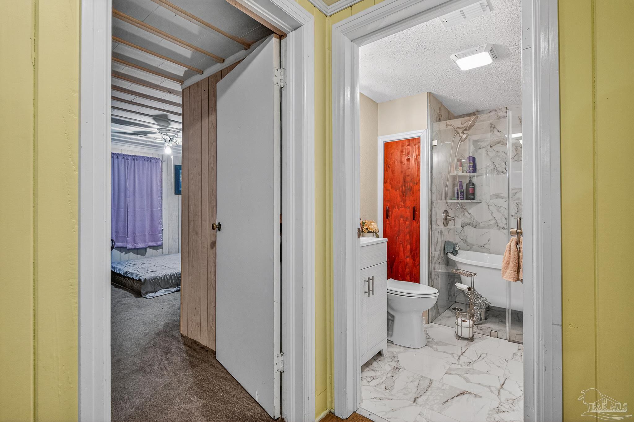 1450 East Burgess Road Pensacola, FL 32504 - Photo 4 of 49 a bathroom with a granite countertop toilet and a shower