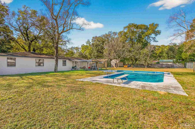 a view of a swimming pool with an outdoor space and seating area