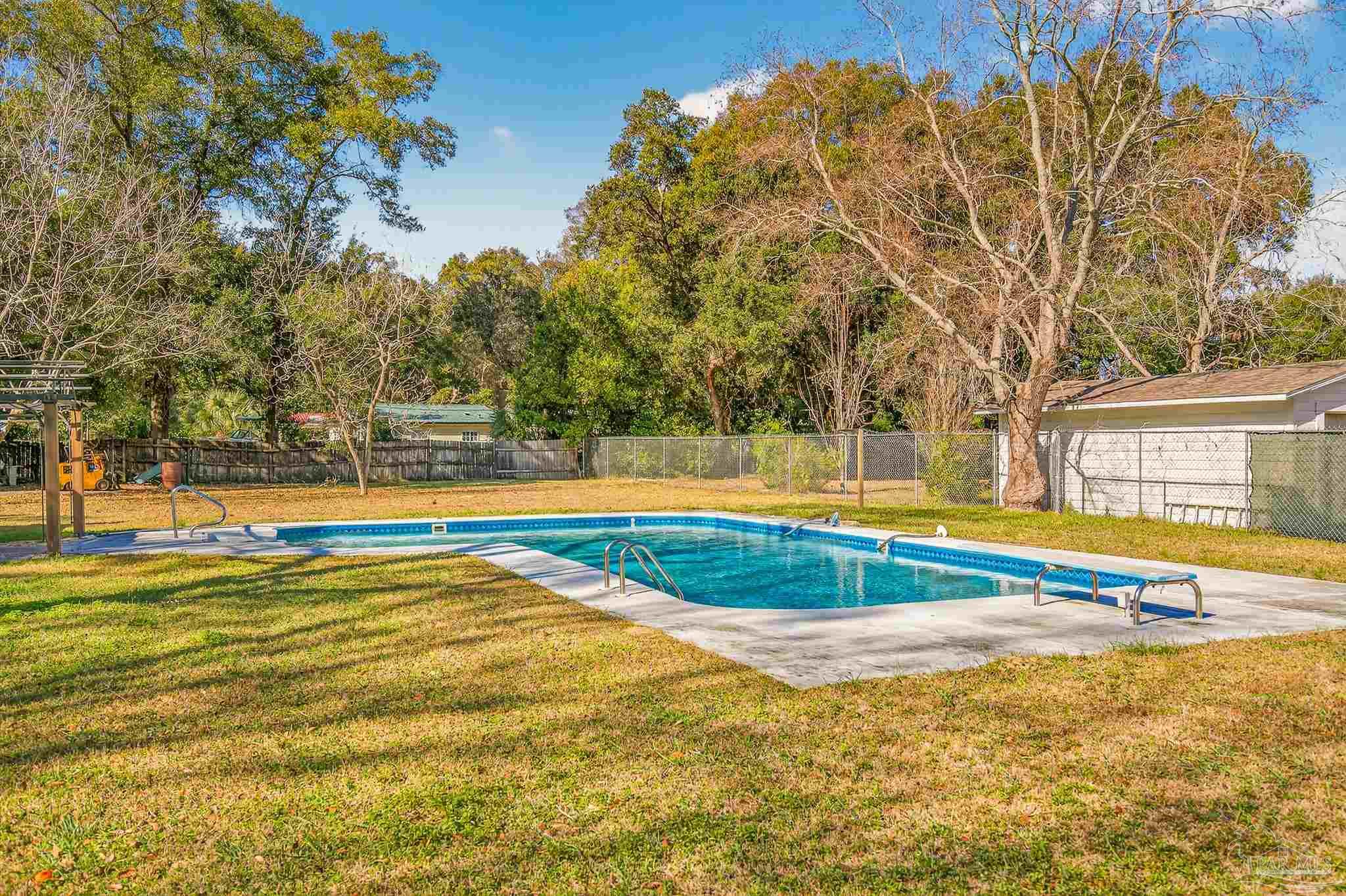 1450 East Burgess Road Pensacola, FL 32504 - Photo 43 of 49 a view of a swimming pool with an outdoor space