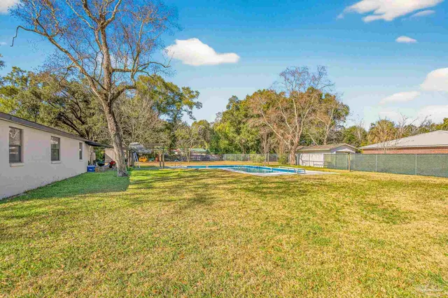 a view of yard and swimming pool
