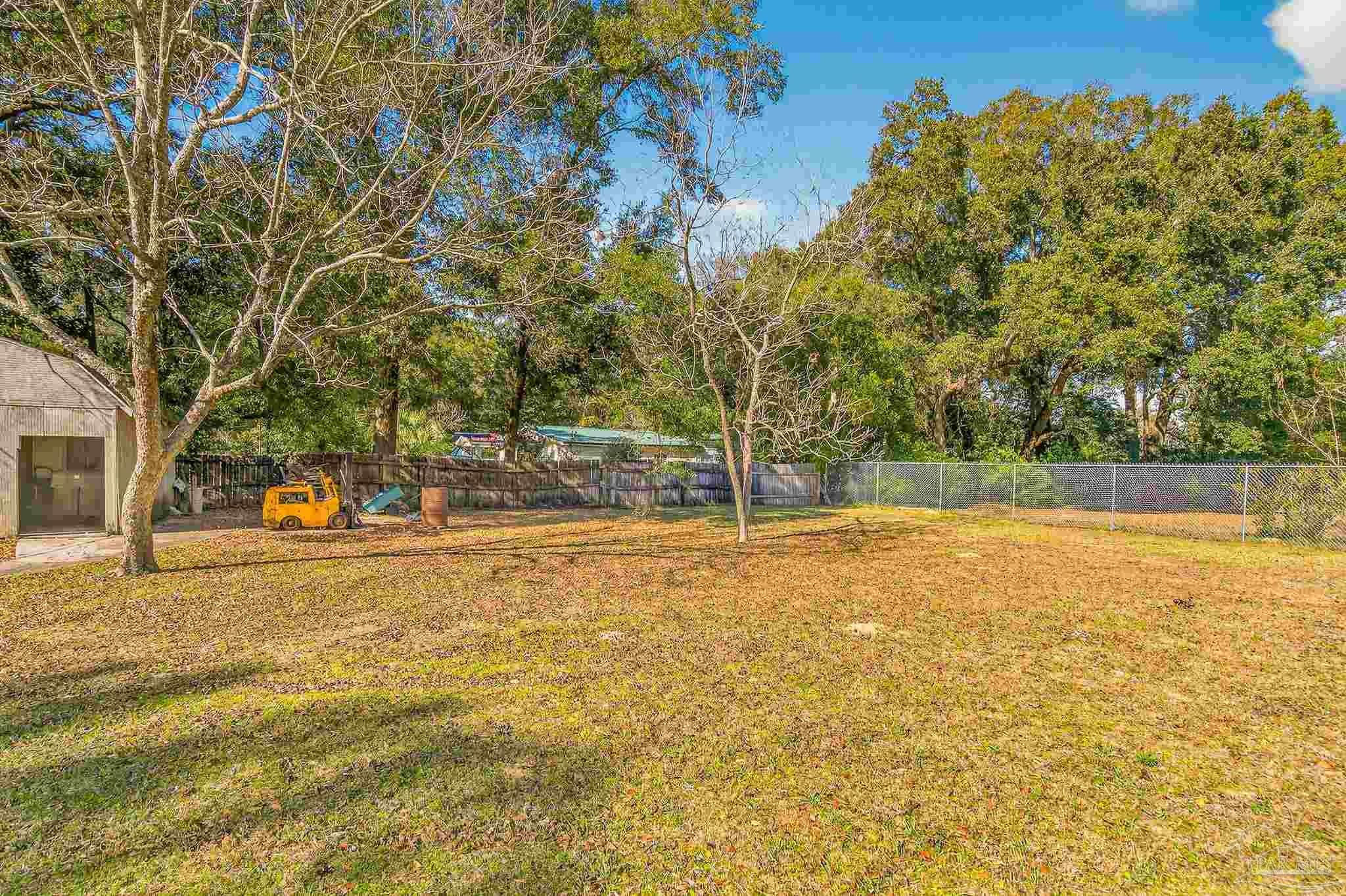 1450 East Burgess Road Pensacola, FL 32504 - Photo 46 of 49 a view of yard with swimming pool and trees