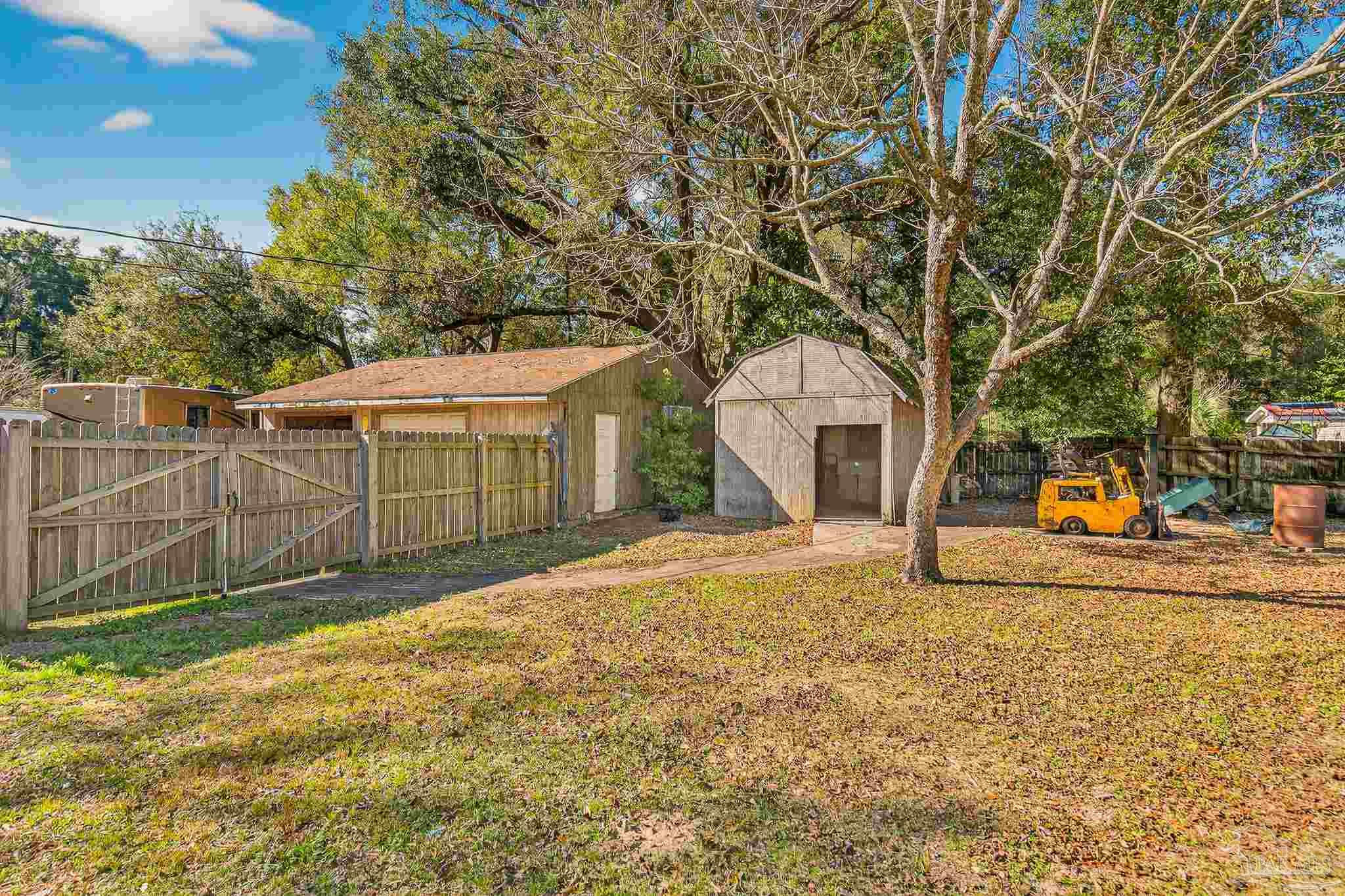 1450 East Burgess Road Pensacola, FL 32504 - Photo 47 of 49 a view of a backyard with a large tree