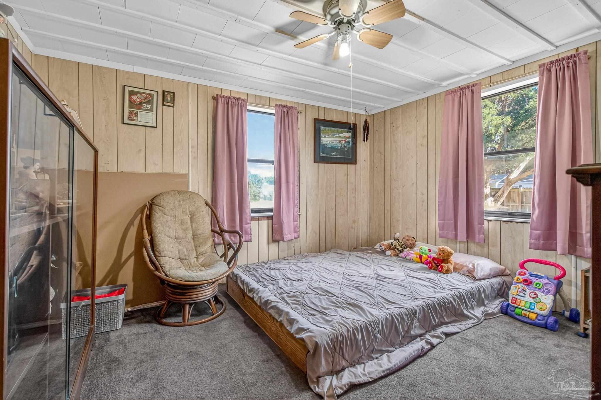 1450 East Burgess Road Pensacola, FL 32504 - Photo 9 of 49 a bedroom with a bed dresser and a window