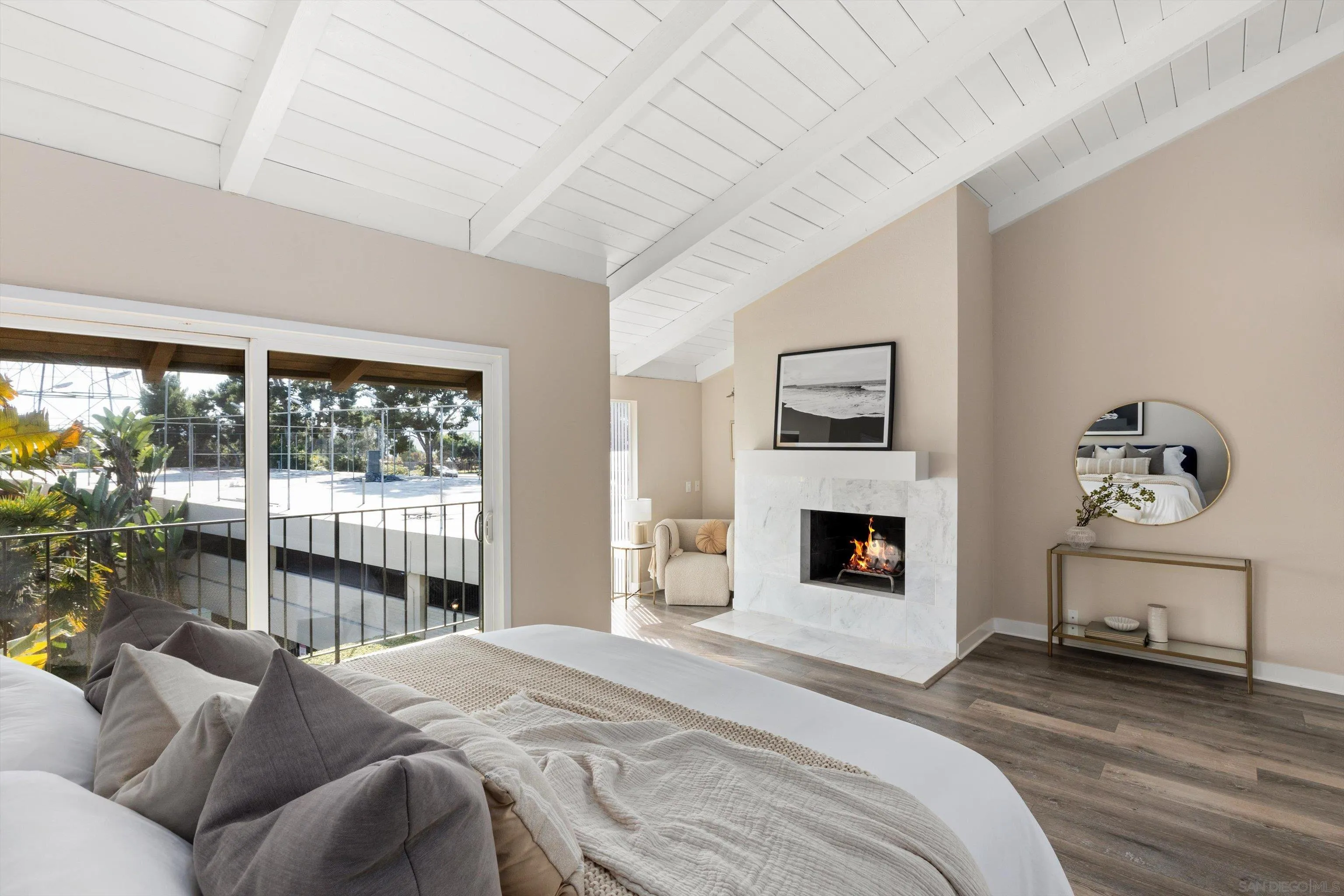 1913 Alga Road, Unit A Carlsbad, CA 92009 - Photo 15 of 44 a bedroom with a bed and a fireplace