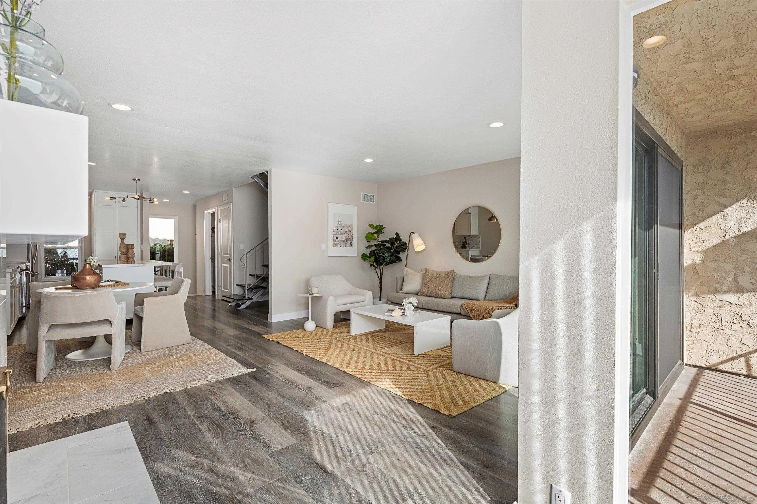 1913 Alga Road, Unit A Carlsbad, CA 92009 - Photo 7 of 44 a living room with furniture a rug and white walls