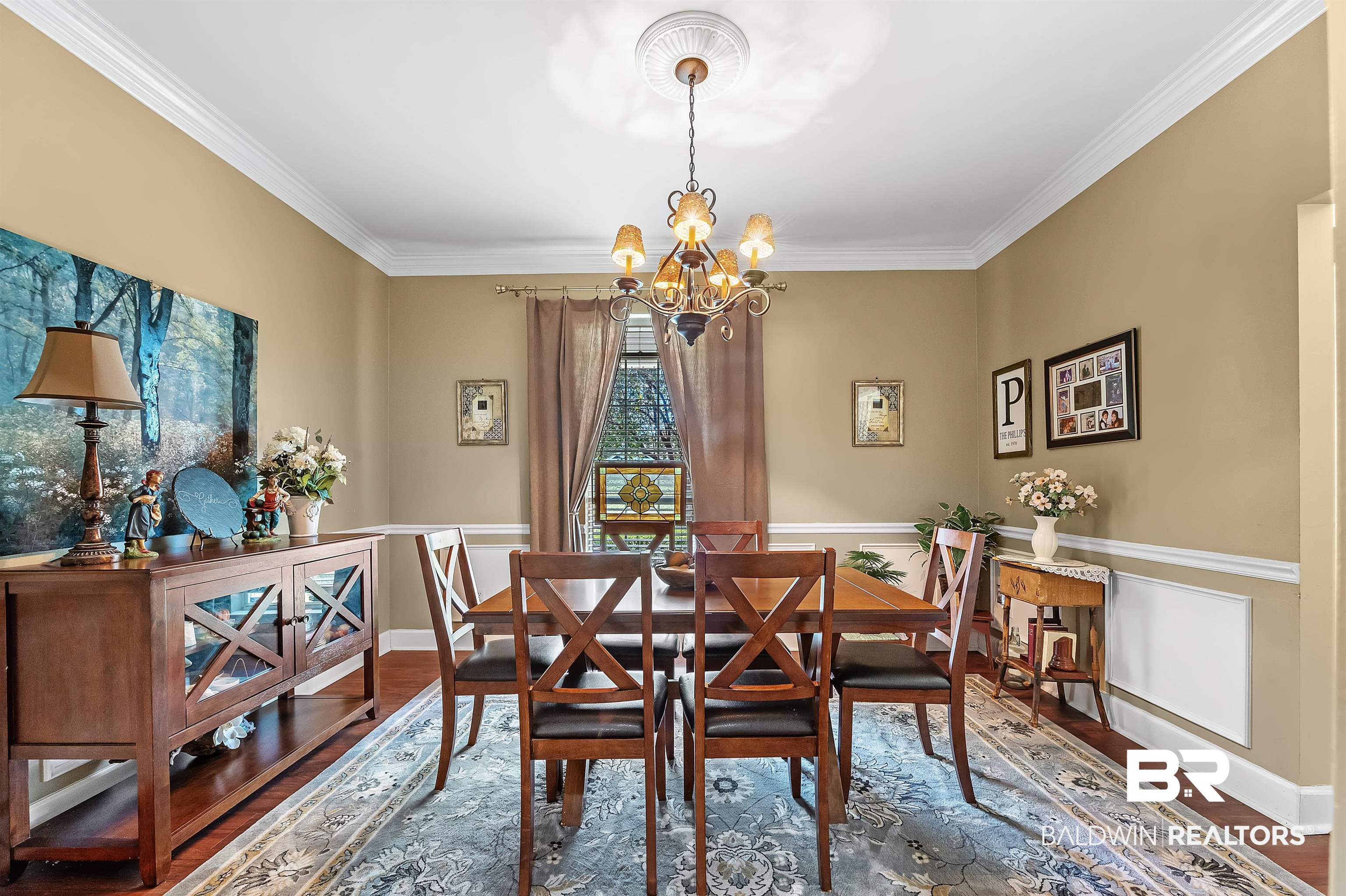 9901 Glover Court Fairhope, AL 36532 - Photo 8 of 52 Dining room with a notable chandelier, hardwood / wood-style flooring, and ornamental molding