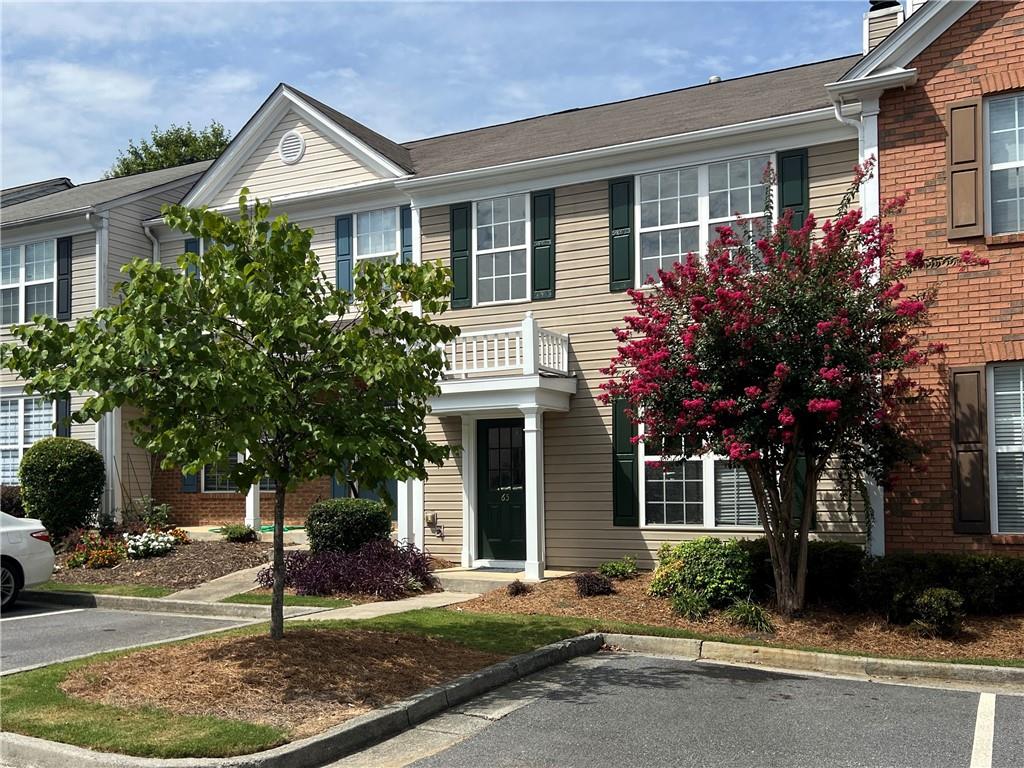13300 Morris Road, Unit 65 Alpharetta, GA 30004 - Photo 1 of 1 a front view of a house with garden
