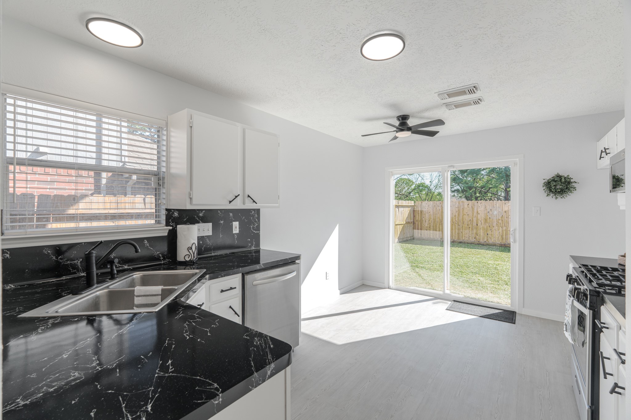 10347 Mist Lane Houston, TX 77070 - Photo 11 of 32 a kitchen with stainless steel appliances granite countertop a sink and a stove
