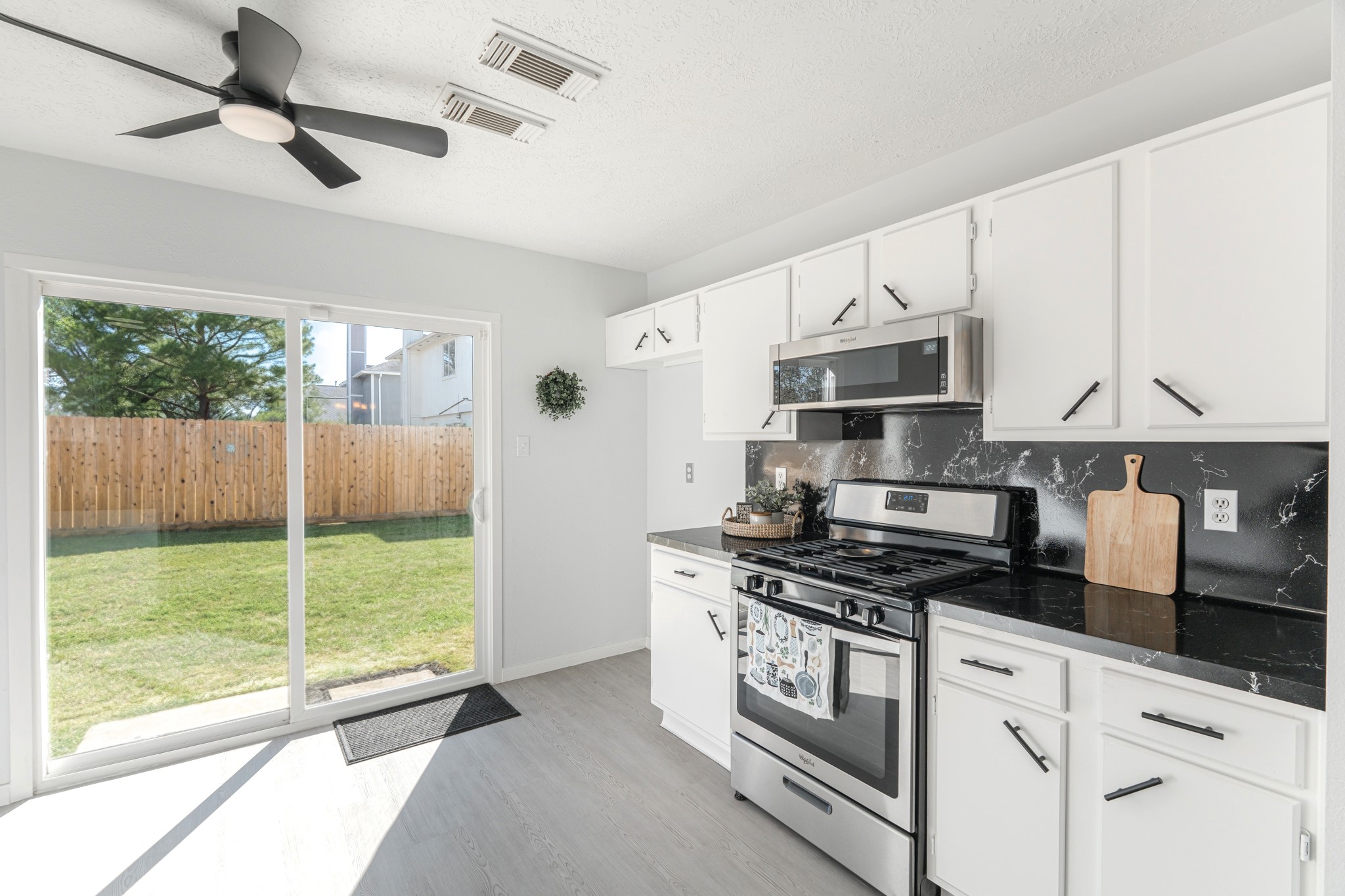 10347 Mist Lane Houston, TX 77070 - Photo 15 of 32 a kitchen with stainless steel appliances a stove a sink and a refrigerator