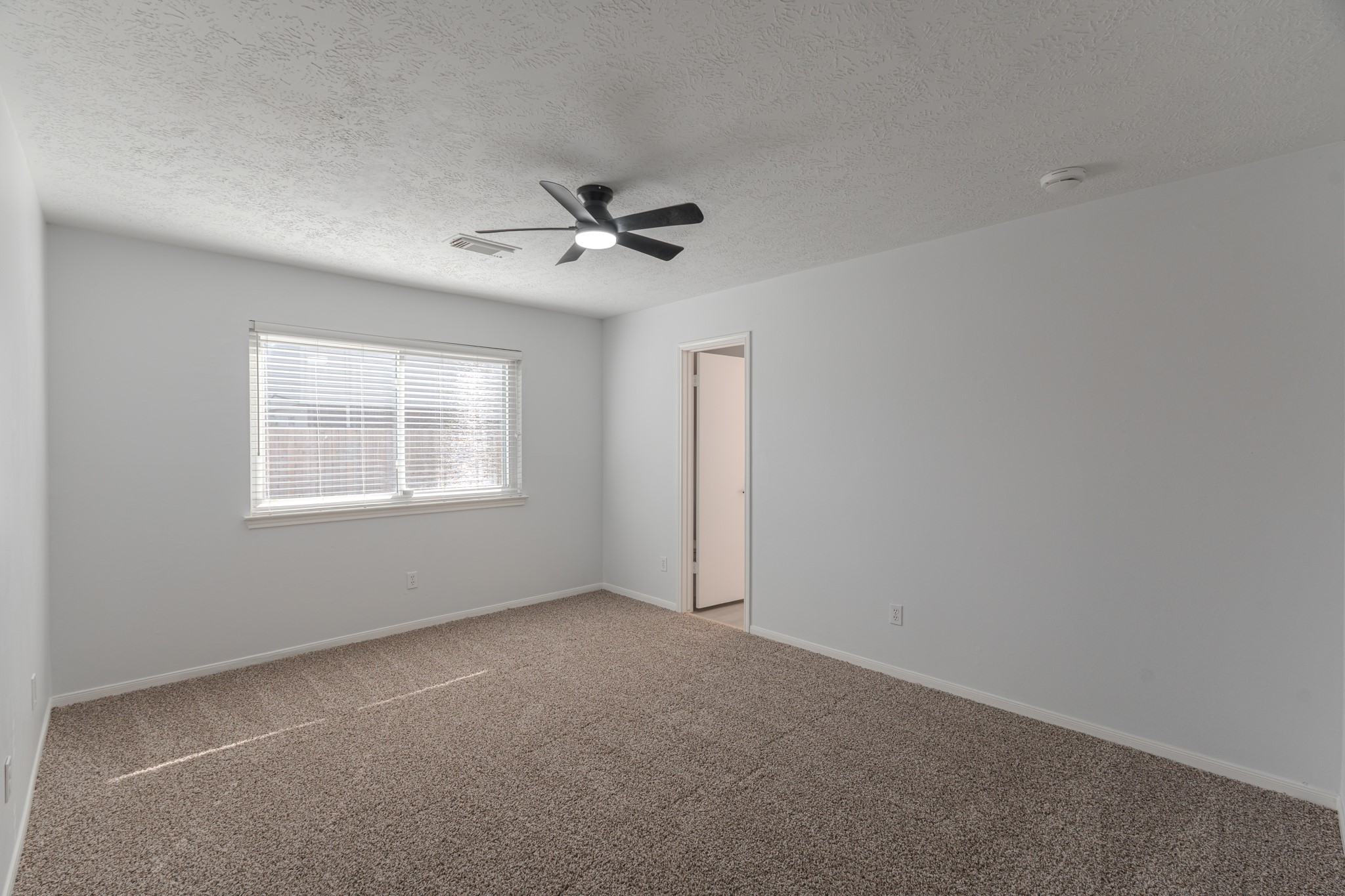 10347 Mist Lane Houston, TX 77070 - Photo 16 of 32 a view of an empty room with a window