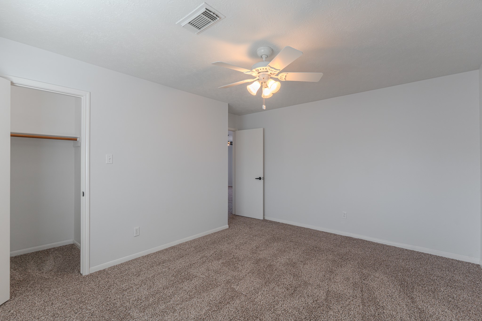 10347 Mist Lane Houston, TX 77070 - Photo 25 of 32 an empty room with a window and chandelier fan