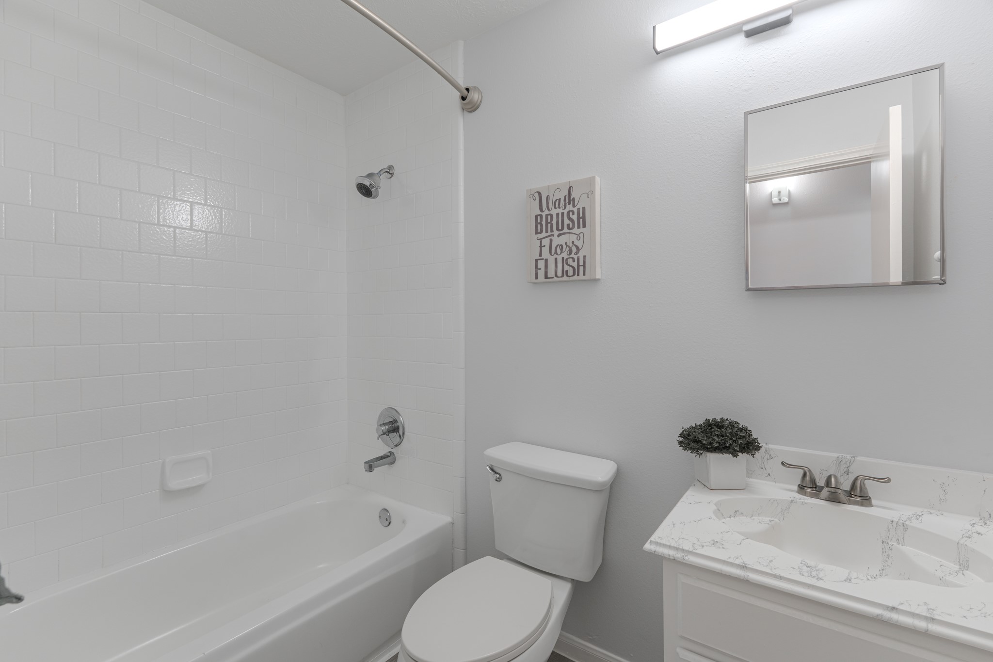 10347 Mist Lane Houston, TX 77070 - Photo 26 of 32 a white toilet sitting next to a bath tub