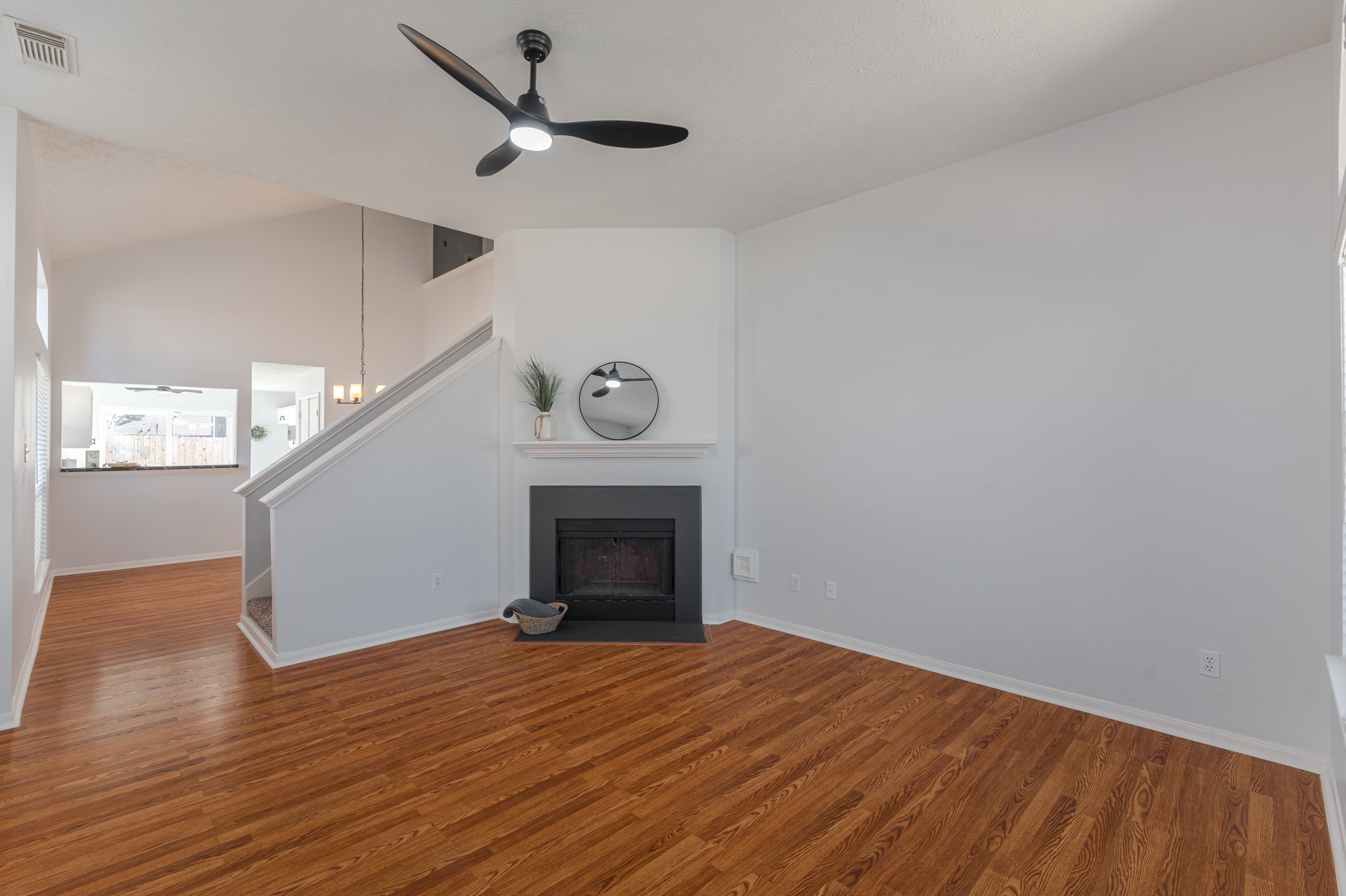 10347 Mist Lane Houston, TX 77070 - Photo 5 of 32 a view of empty room with wooden floor and fireplace