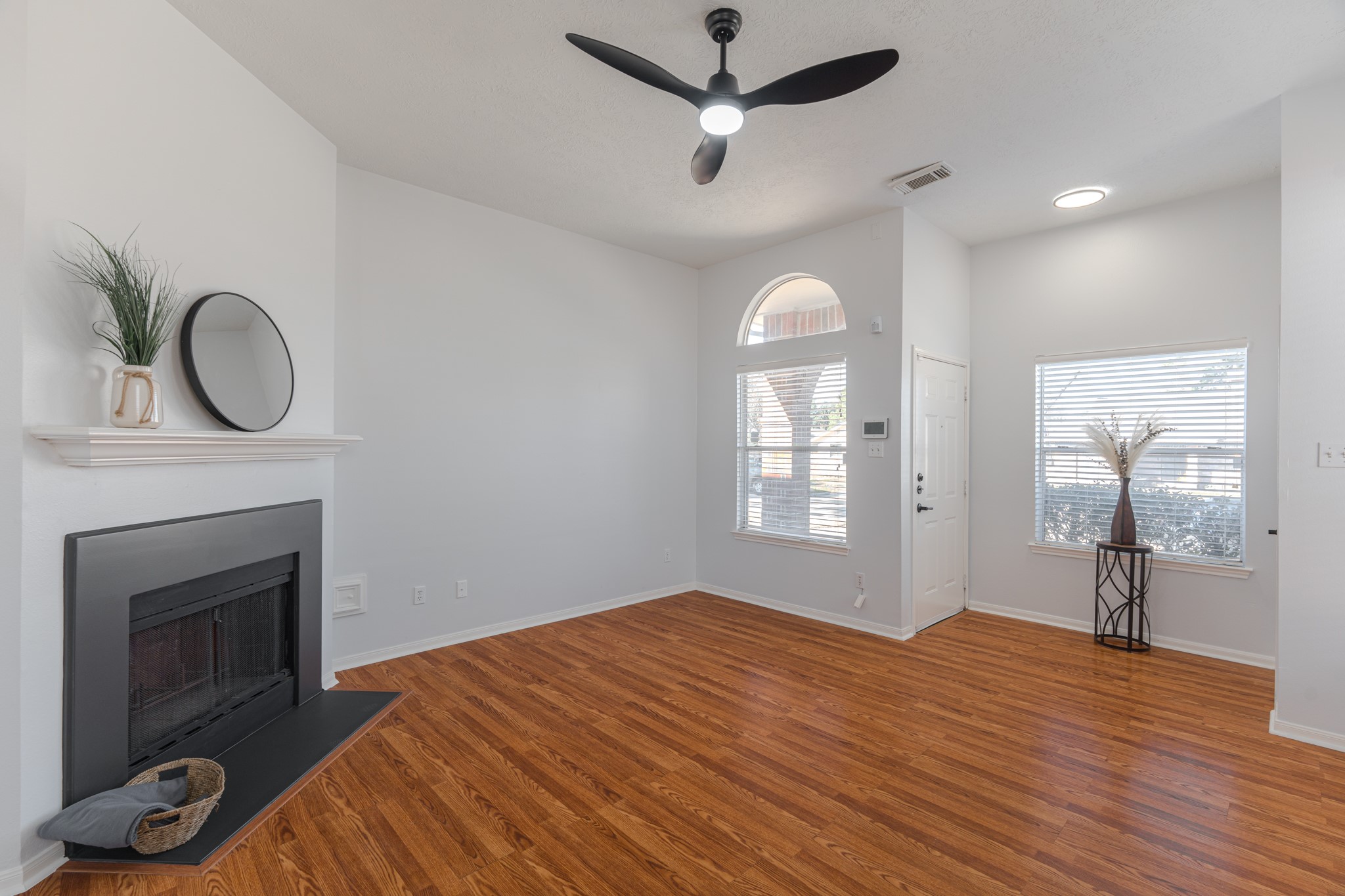 10347 Mist Lane Houston, TX 77070 - Photo 6 of 32 a bedroom with furniture a fireplace and wooden floor