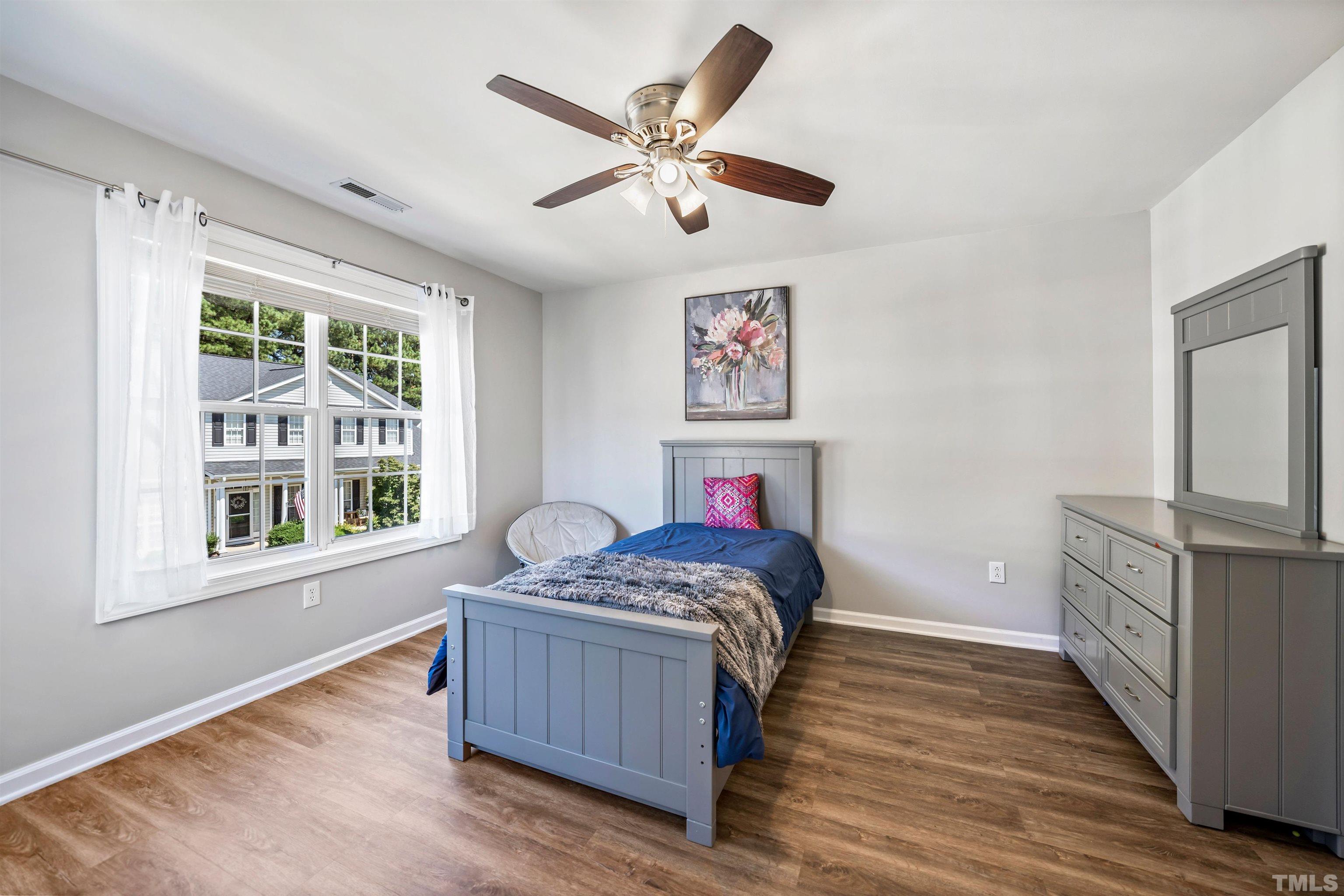 3012 White Cloud Circle Apex, NC 27502 - Photo 14 of 31 a bedroom with a bed and wooden floor