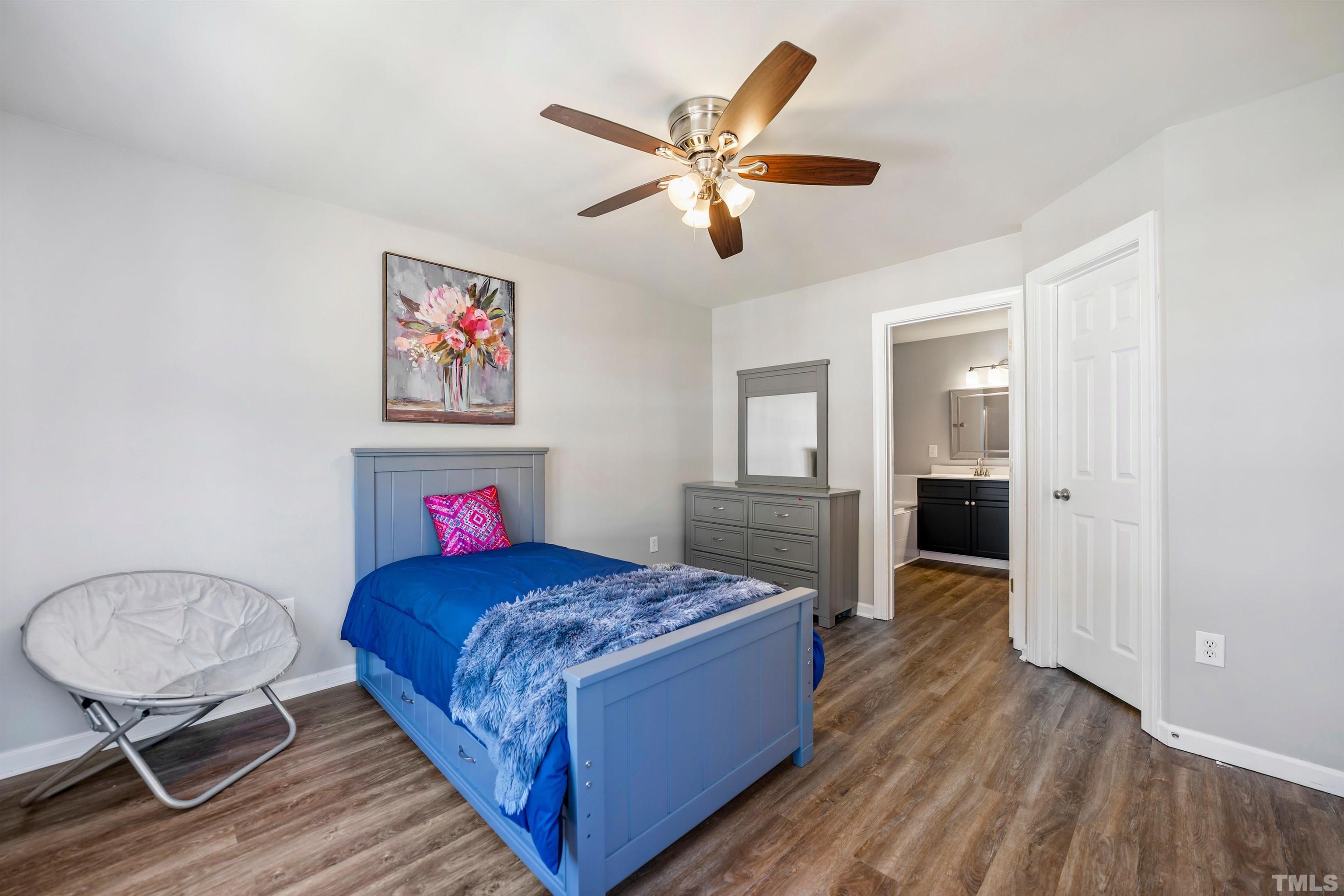 3012 White Cloud Circle Apex, NC 27502 - Photo 15 of 31 a bedroom with a bed and a chandelier