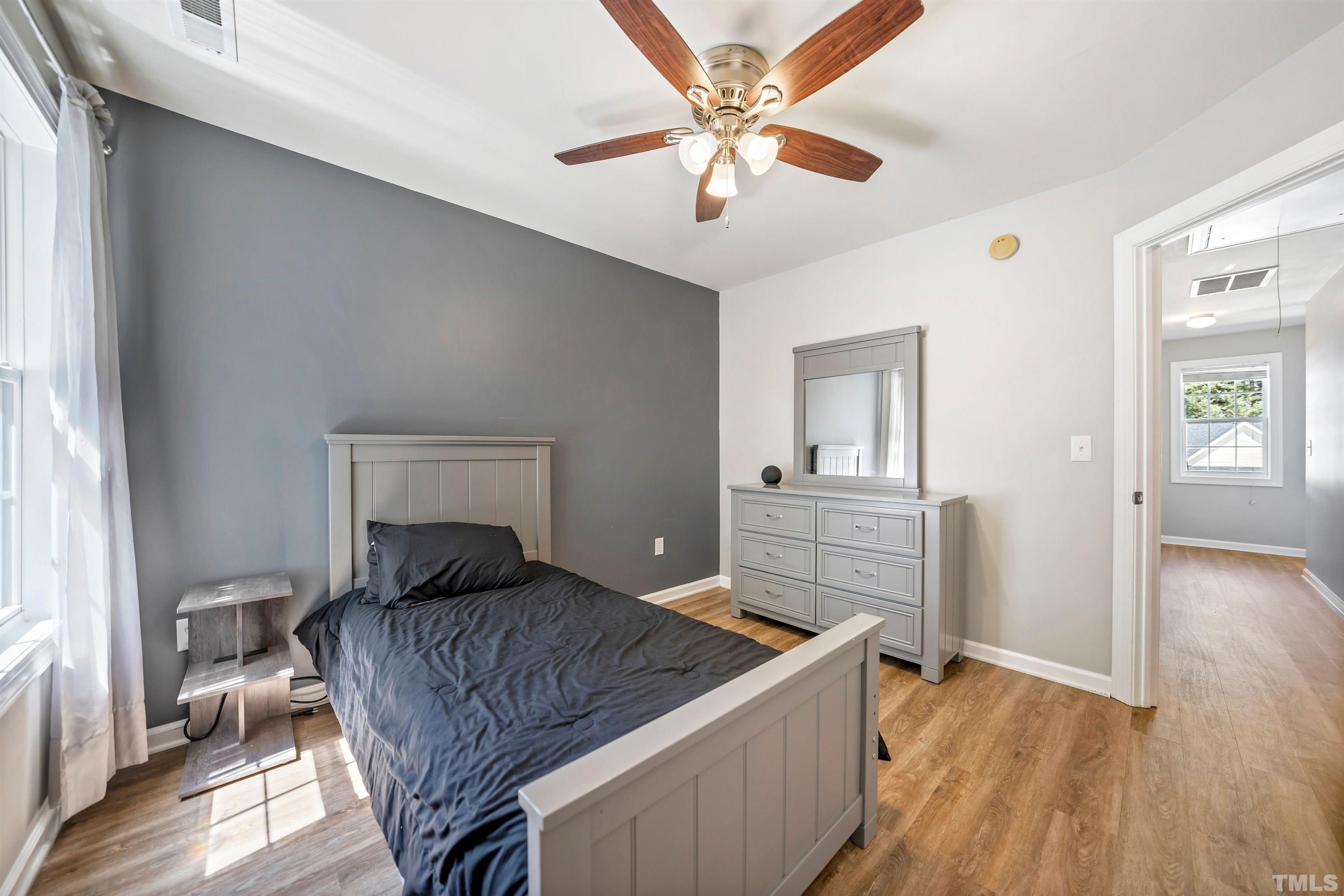 3012 White Cloud Circle Apex, NC 27502 - Photo 18 of 31 a bedroom with a bed and a chandelier
