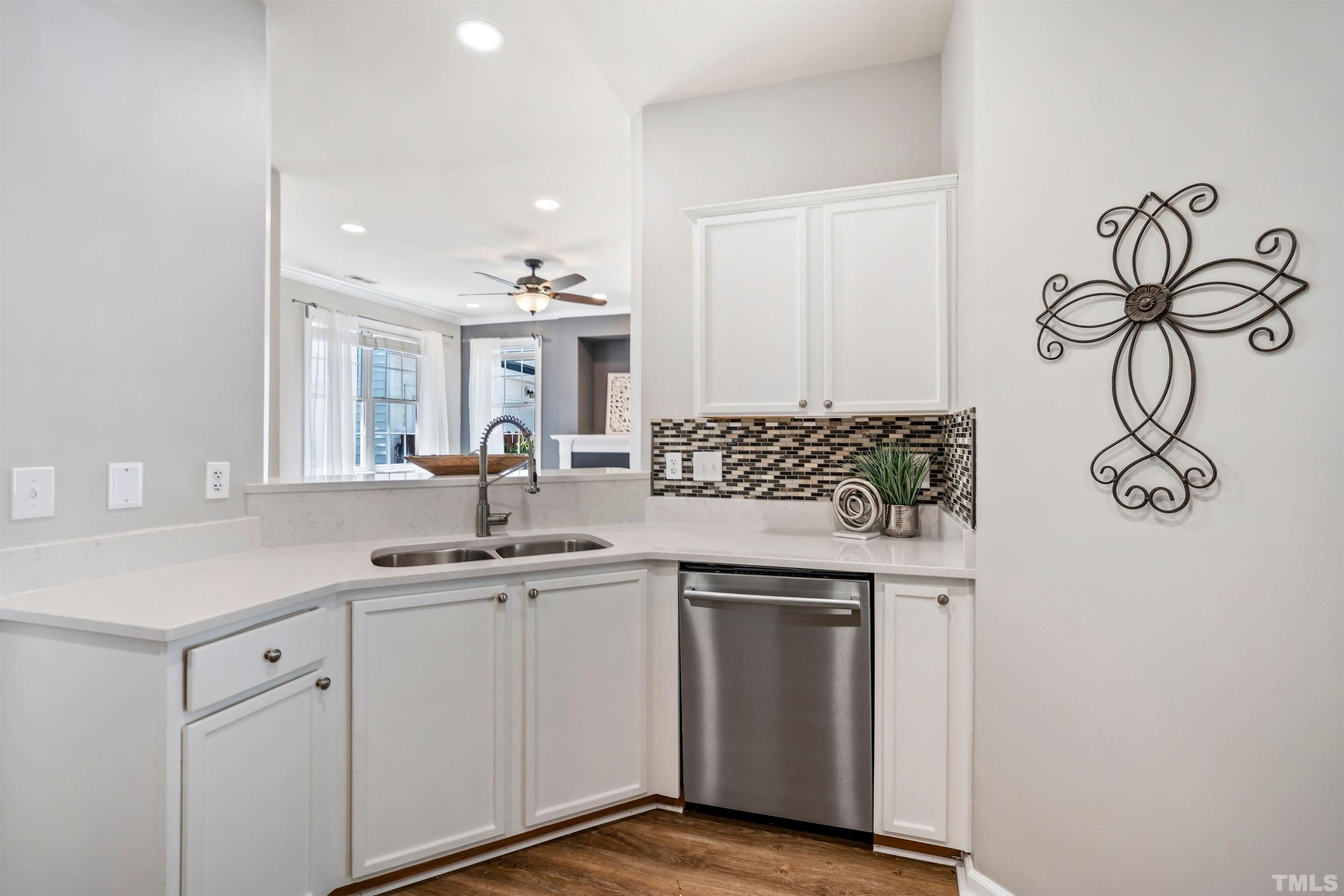 3012 White Cloud Circle Apex, NC 27502 - Photo 6 of 31 a kitchen with a sink and cabinets